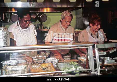 Volunteers at senior citizens center prepare meals for Meals on Wheels delivery Stock Photo