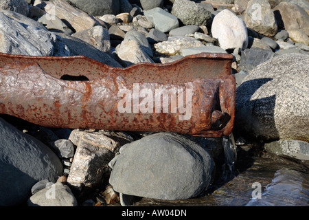 The remains of an old rusted pipe on the shoreline of Fort Dearborn which is an old Military fort located in Rye New Hampshire. Stock Photo