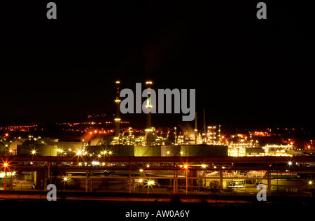 Night view of a petrochemical refinery with chimneys and storage tanks Stock Photo