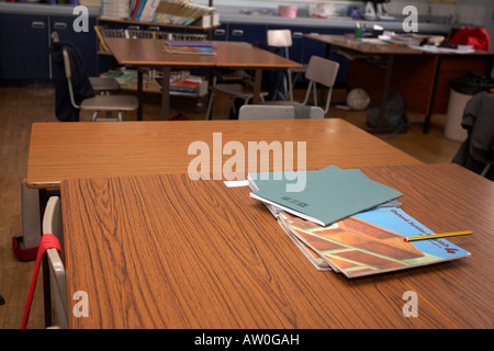 schoolbooks and english textbooks sitting on tables in an empty primary school classroom belfast northern ireland uk Stock Photo
