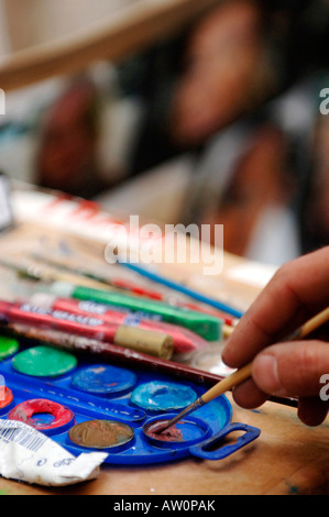 Face painters plying their craft to participants in the Venice carnival in Venice Italy 2008 Stock Photo