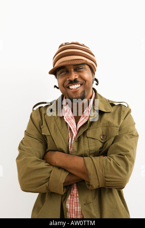 African American mid adult man wearing hat and smiling at viewer with arms crossed Stock Photo