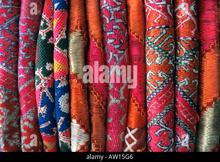 Stack of everyday and ceremonial hand embroidered silk and woven fabrics from Pakistan Stock Photo