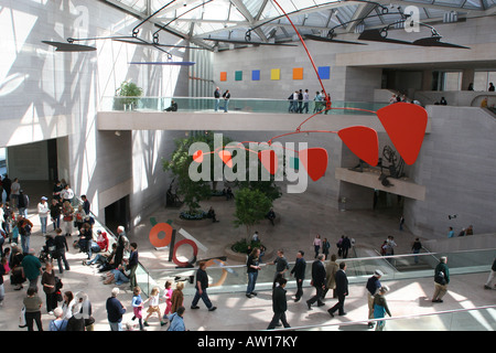 Visitors below the Alexander Calder Mobile in the central court of the National Gallery of Art Stock Photo