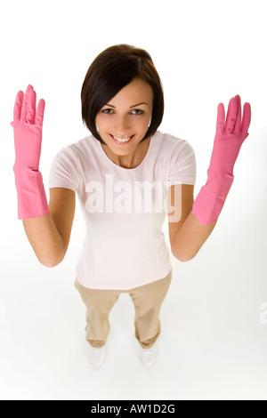 Young happy woman in pink rubber gloves with raised hands Looking at camera high angle view White background Stock Photo