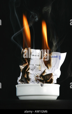 Insurance policy is burning Stock Photo