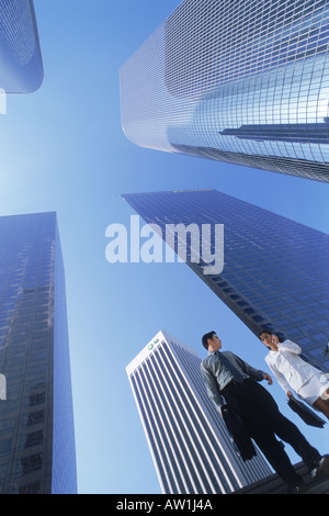 Businessman and woman under downtown Los Angeles skyscrapers Stock Photo