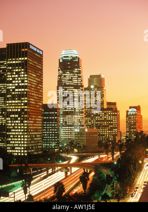 Downtown Los Angeles with rush hour traffic passing on roads and freeways at dusk Stock Photo