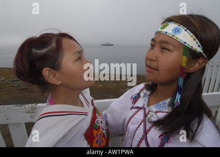 Model released inuit teens throat singing wearing their traditional clothing MR Pond Inlet Baffin Island High Arctic Canada isol Stock Photo