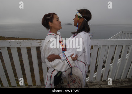 Model released inuit teens throat singing wearing their traditional clothing MR Pond Inlet Baffin Island High Arctic Canada isol Stock Photo