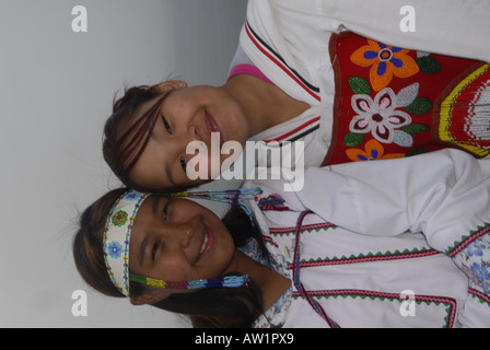 Model released inuit teens throat singing wearing their traditional clothing MR Pond Inlet Baffin Island High Arctic Canada isol Stock Photo