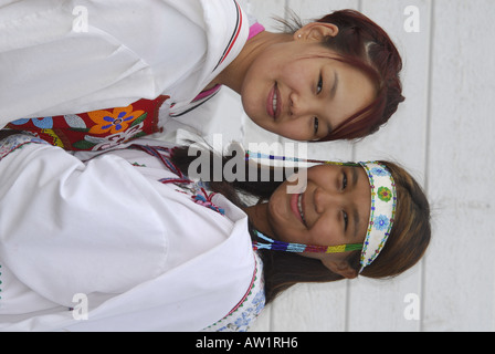 Model released inuit teens throat singing wearing their traditional clothing MR Pond Inlet Baffin Island High Arctic Canada isol Stock Photo