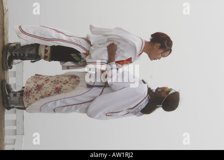 Model released inuit teens throat singing wearing their traditional clothing MR Pond Inlet Baffin Island High Arctic Canada isol Stock Photo