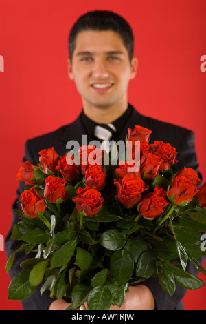 Handsome man with bouquet of roses Stock Photo - Alamy