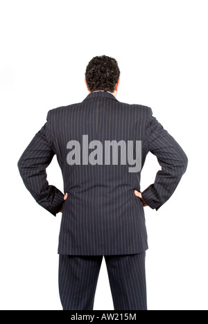 Rear view of a confident businessman wearing a suit hands on hips Stock Photo