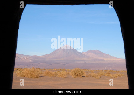 Chile Atacama  Desert doorway frames Andes mountains with snow at the Aldea de Tulor village archaeological ruins Stock Photo