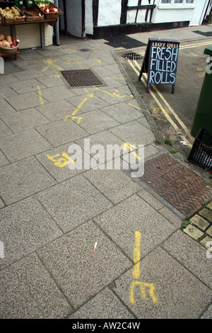 Pavement in a picturesque environment, but with the inevitable double yellow lines, has multiple markings on it in yellow paint Stock Photo