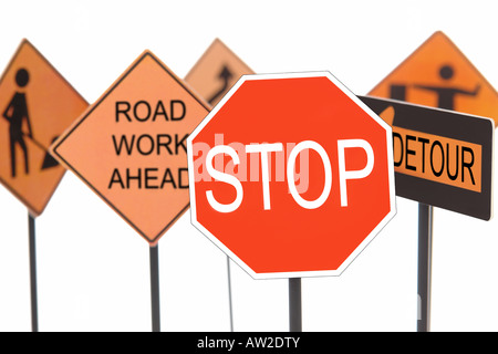 Closeup of stop sign with various american road construction signs in the background Stock Photo