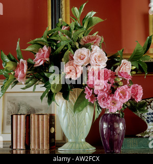 a vase with freshly cut roses in various shades of pink Stock Photo