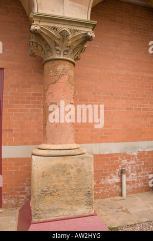 red brick victorian pillar with peeling paint Stock Photo