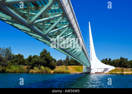 The glass deck of Sundial Bridge in Redding California casts a green tint on trusses over Sacramento River Stock Photo