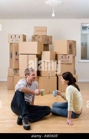 Couple taking a break from unpacking Stock Photo