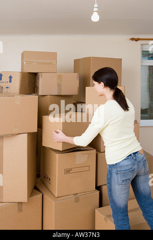 Woman stacking cardboard boxes Stock Photo