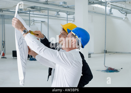 Architects looking at plans Stock Photo