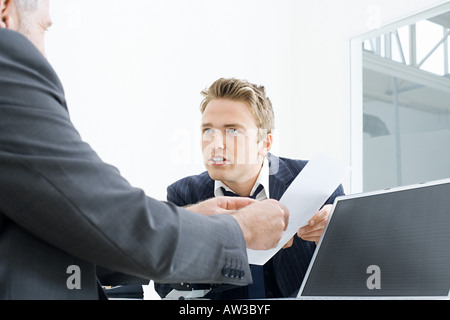 Businessmen with a piece of paper Stock Photo