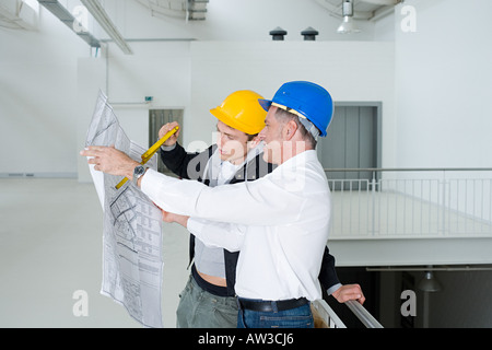 Architects looking at plans Stock Photo