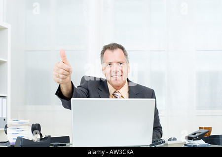 Businessman giving thumbs up Stock Photo