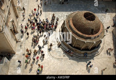 Ariel view taken from the Old Town's historic wall showing tourists enjoying Dubronivk's Stradun and Onofrio's Fountain Stock Photo