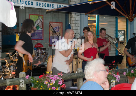 Rock band performing at night outside cafe in town square Hesdin Pas de Calais Part of the National Fete de la Musique event Stock Photo