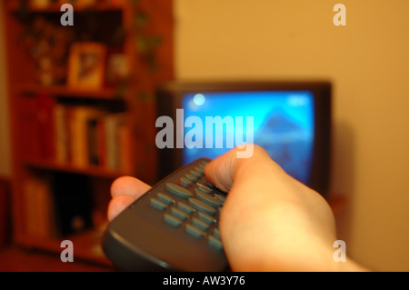 Hand with remote control Stock Photo