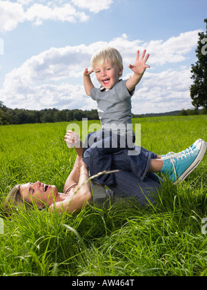 Mother and son playing in field Stock Photo - Alamy