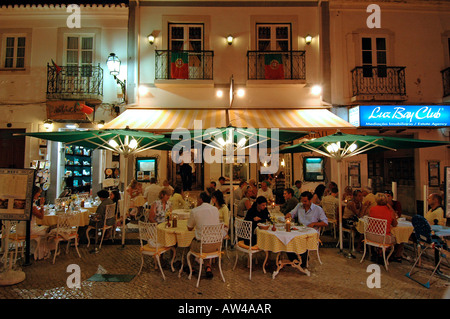 Customers dine outside at a restaurant in Avenida dos Descobrimentos in the town of Lagos in Algarve the southernmost region of Portugal Stock Photo