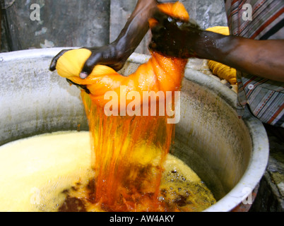 man wringing cloth during dyeing delhi india Stock Photo