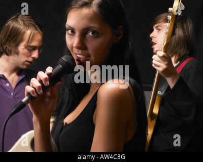 Woman singing in a band.