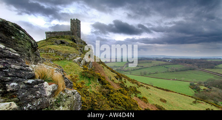 Dramatic stormy skies over The Church of St Michael on Brent Tor within Dartmoor National Park South Devon in Panoramic format Stock Photo