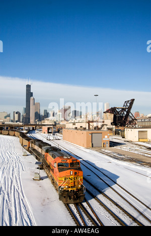 A BNSF coal train heads east under the skyline of Chicago. Stock Photo