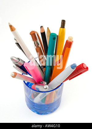 Colourful pens and pencils in a blue glass on a white background Stock Photo