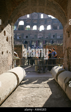 Unusual view of tourists visiting the popular ancient landmark remains of the Colosseum central Rome Italy capital European city Stock Photo