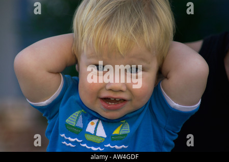 baby with arms behind back Stock Photo