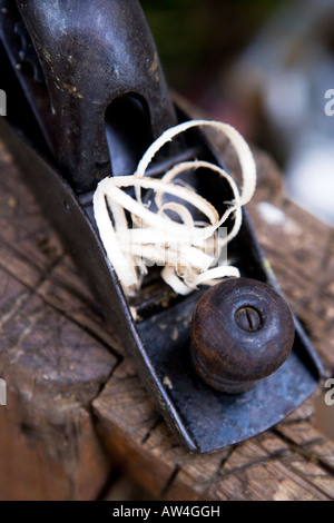 Still life of an old woodwork plane with wood shavings Stock Photo