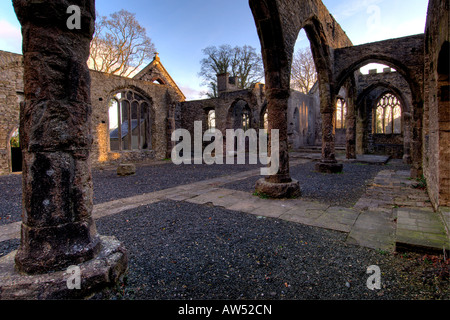 Interior of a burnt out church attacked by arsonists and left as a ruinous shell with warm morning light and blue sky Stock Photo