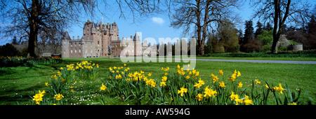 Glamis Castle childhood home of the Queen Mother showing daffodils in foreground springtime Angus Scotland UK Stock Photo