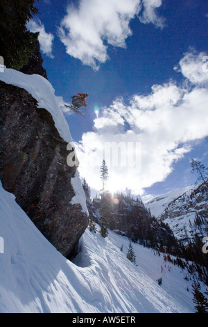 Skier jumps from large cliff, San Juan Range Stock Photo