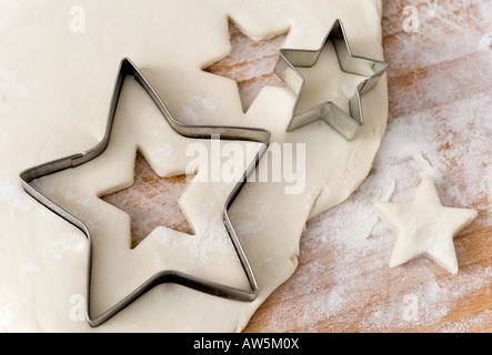 Raw pastry with star shaped cookie cutters Stock Photo