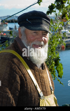 An old fisherman with a white hat is fishing with his fishing pole on the  pier of the harbor (Pesaro, Italy, Europe Stock Photo - Alamy