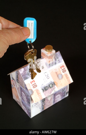 Property and Housing Prices Model home covered in british banknotes